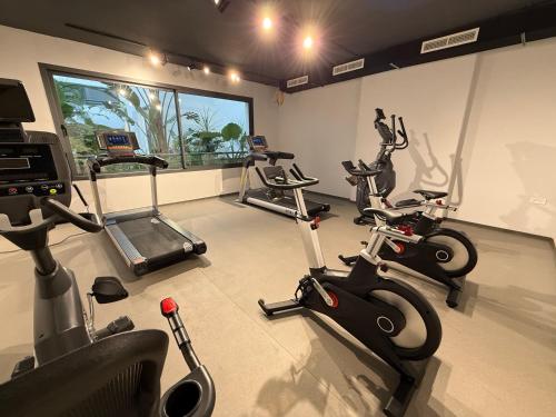 a gym with three exercise bikes in a room at Appartement Uptown CFC - Piscine - Gym - Parking Gratuit in Casablanca