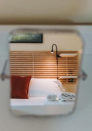 a view of a bedroom with a bed and a lamp at Tims Vista Bella - Mezzegra, Tremezzina by LoveComo in Lenno