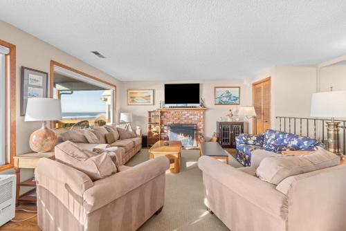 a living room with couches and a fireplace at Boone Family Retreat in Lincoln Beach