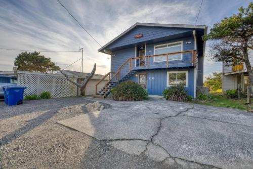 a blue house with a porch and a driveway at Boone Family Retreat in Lincoln Beach