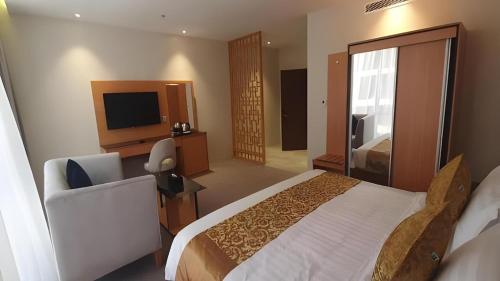 a hotel room with a bed and a television at فندق الريان Ryan Hotel in Jeddah