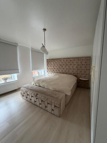 a bedroom with a large bed in a room at La Priva House in Charleroi