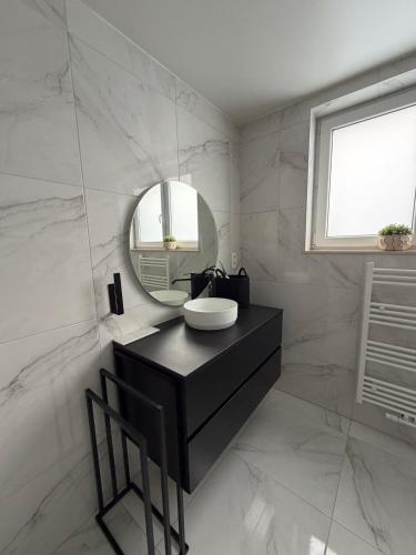 a bathroom with a sink and a mirror at La Priva House in Charleroi
