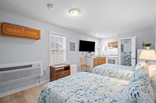 a hotel room with two beds and a kitchen at Vitamin Sea Suites 3 in Carolina Beach