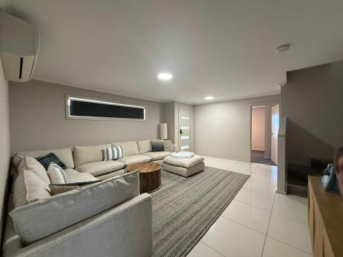 a living room with a couch and a table at Aldinga Beach Reef Escape in Aldinga Beach