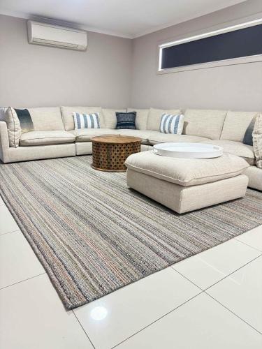 a living room with a couch and a rug at Aldinga Beach Reef Escape in Aldinga Beach