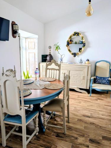 a dining room with a table and chairs and a mirror at Vida à portuguesa, Charming apartment "Algarve" , in the cultural and historical center in Portimão