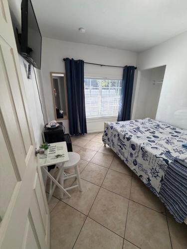 a bedroom with a bed and a table and a window at B5 Best Value on Private Bedroom with Private Bathroom in Little Havana, Miami in Miami