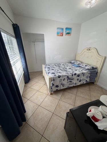 a small bedroom with two beds and a window at B5 Best Value on Private Bedroom with Private Bathroom in Little Havana, Miami in Miami