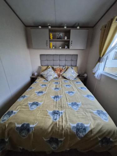 a bedroom with a large bed with blue flowers on it at Hills residence in Morecambe