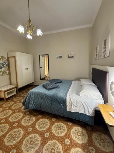 a bedroom with a bed and a table and a mirror at Donna Felì in Gragnano