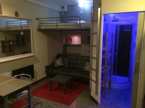 a living room with a couch and a bunk bed at Studio sur agde, avec cour, parking et spa en option à 30e par jour in Agde