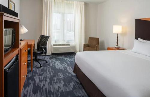 a hotel room with a bed and a television at Fairfield Inn & Suites Orange Beach in Orange Beach