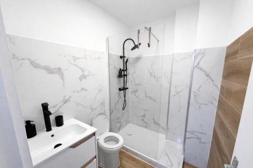 a white bathroom with a shower and a sink at Maison Connectée Serenia in Méru