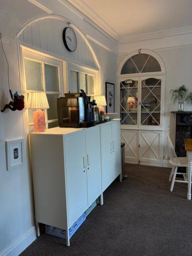 a kitchen with a counter and a clock on the wall at The Dozy Deer in Windermere