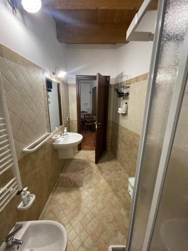 a bathroom with a sink and a toilet and a mirror at Casa di nonno Agostino in San Severino Lucano