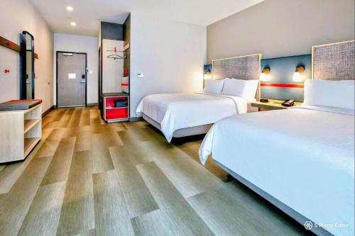 a hotel room with two beds and wooden floors at Americas Best Value Inn Providence-North Scituate in North Scituate