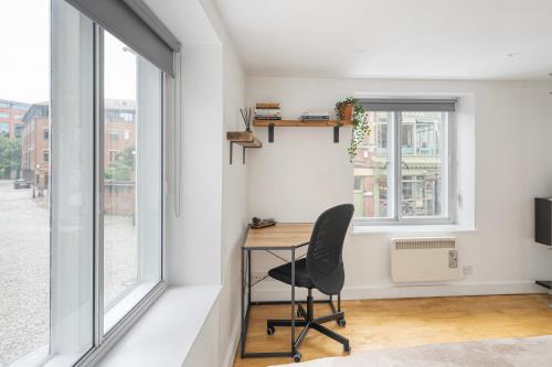 an office with a desk and a chair in a room with windows at Central Apt-2Bed 2Bath-AC unit-By FabAccommodation in Bristol