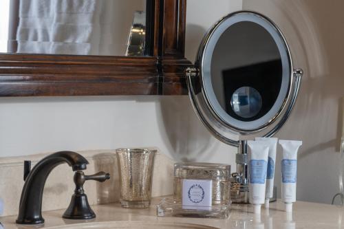 a bathroom counter with a mirror and a sink at Hotel Granduca Houston in Houston