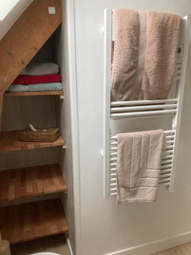 a closet with towels hanging from the door at Ty Moune in Crach