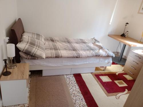 a bedroom with a bed with a blanket on it at 150 metres from the beach dafnes Patra in Patra