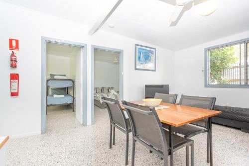 a dining room with a table and chairs at Koala Lodge Unit 3 in Iluka