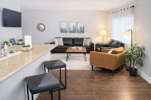 a living room with a couch and a table at Condo with Sauna & Fitness Center, Adjustable Base King Sized Bed in Coeur d'Alene