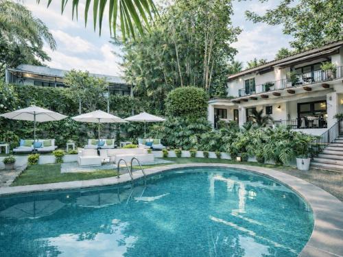 a swimming pool in front of a house at Las Casas B&B Boutique Hotel, Spa & Restaurante Cuernavaca in Cuernavaca