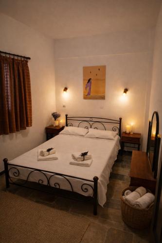 a bedroom with a bed with two towels on it at villa Belian 3 in Argalasti