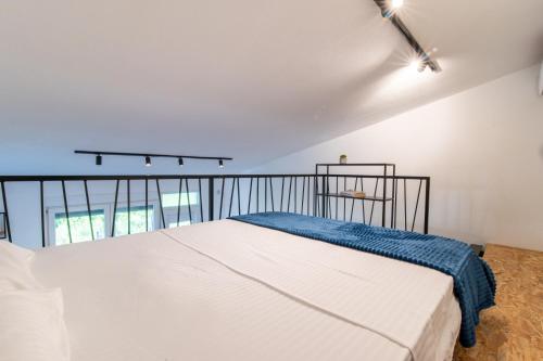 a bedroom with a large white bed in a room at Pink bird apartments and FREE PARKING in Virpazar