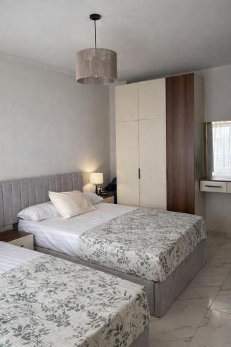 two beds in a room with two beds sidx sidx sidx at Arian North Coast Chalet Santorini Resort El Alamein in El Alamein