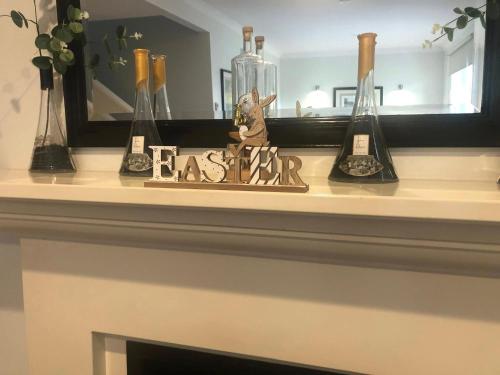 a mantel with a mirror and some vases on it at Villa Above Par, Cypress Lakes Resort, Premier 2 Storey Villa, 2 Bedrooms, both with Private Ensuites, Light Breakfast included in Pokolbin