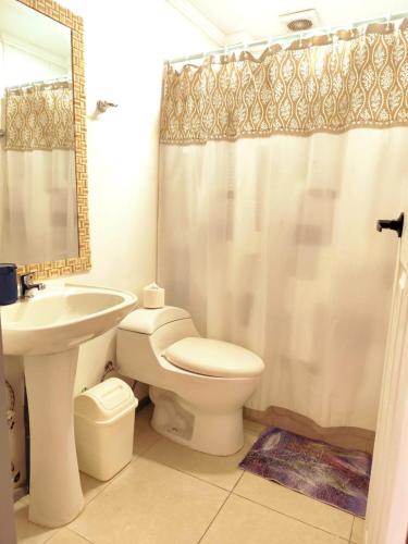 a bathroom with a sink and a toilet and a shower at Hotel Marluz in Mejillones