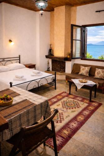 a bedroom with two beds and a table and a couch at Villa Belian 1 in Argalasti