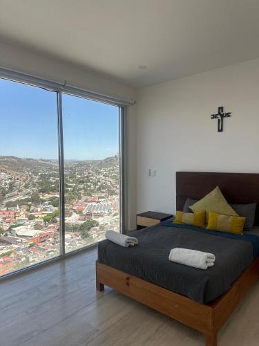 a bedroom with a large bed with a large window at Departamento en Yatay Towers in Hércules