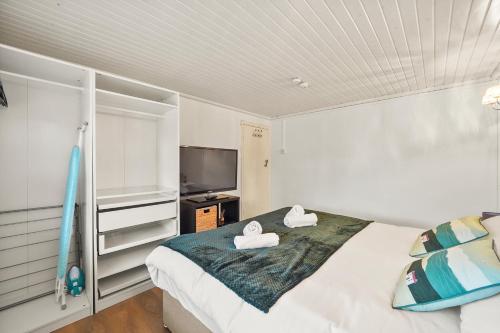 a bedroom with a bed with two towels on it at Private 2Bed-Parking & Garden-By FabAccommodation in Bristol