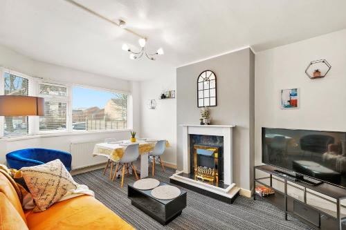 a living room with a table and a fireplace at Private 2Bed-Parking & Garden-By FabAccommodation in Bristol