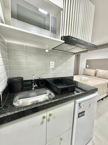 a kitchen with a sink and a bed in a room at G5 Beach Flat Intermares 304 in Cabedelo