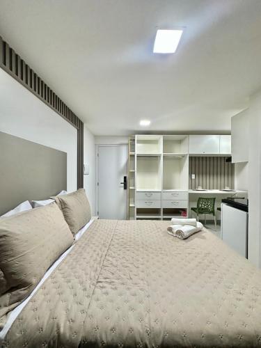 a bedroom with a large bed and a desk at G5 Beach Flat Intermares 304 in Cabedelo