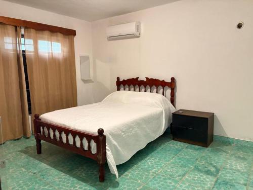 a bedroom with a bed and a dresser in it at GalHaus in Bacalar