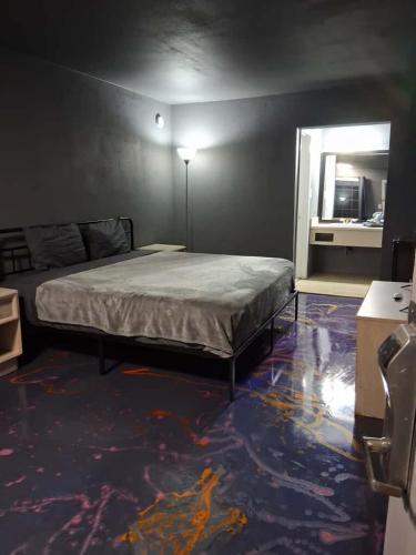 a bedroom with a bed in a room with a mirror at King Bed Hotel Room 255 in Jackson