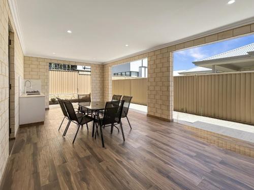 a dining room with a table and chairs at Spacious 4 bed home with open plan living in Perth
