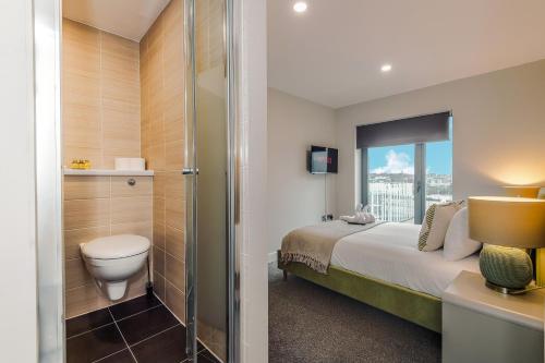 a bathroom with a bed and a toilet and a shower at Luxury 2-Bed Apt by Royal Albert Dock & M&S Arena in Liverpool