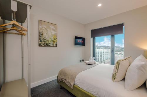 a bedroom with a bed and a large window at Luxury 2-Bed Apt by Royal Albert Dock & M&S Arena in Liverpool