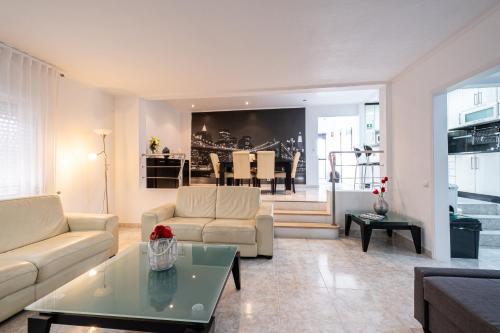 a living room with a couch and a table at Simon's Place in Ponta Delgada