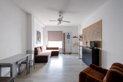 a living room with a couch and a table at Simon's Place in Ponta Delgada
