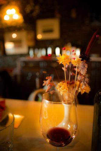 a glass vase with flowers in it on a table at Hotel Can Borrell in Meranges