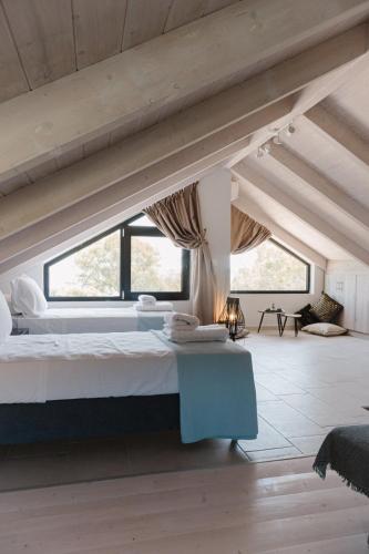 a bedroom with a large bed in a attic at Ariti Luxury Apartment in Nikiana