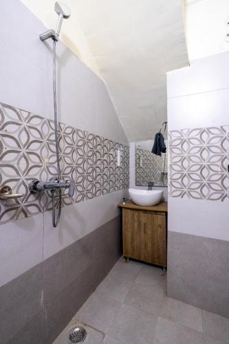 a bathroom with a sink and a shower at By the Lake Boho Bhimtal in Bhīm Tāl