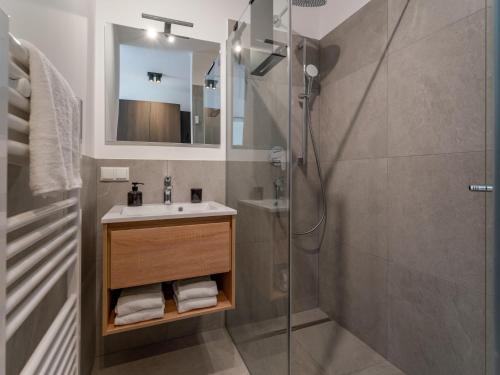 a bathroom with a sink and a shower at Grebenzen Lodge 55 in Sankt Lambrecht